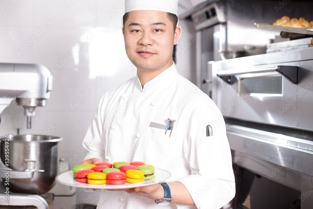 young man chelf makes food in kitchen