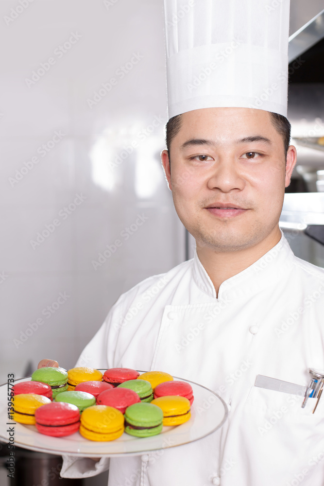 young man chelf makes food in kitchen