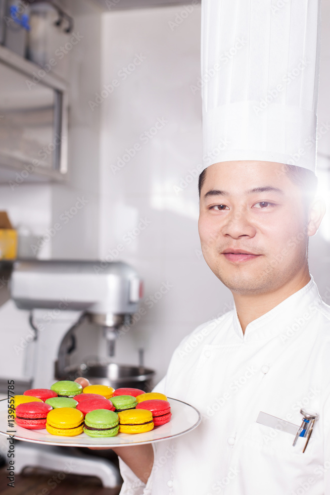 young man chelf makes food in kitchen