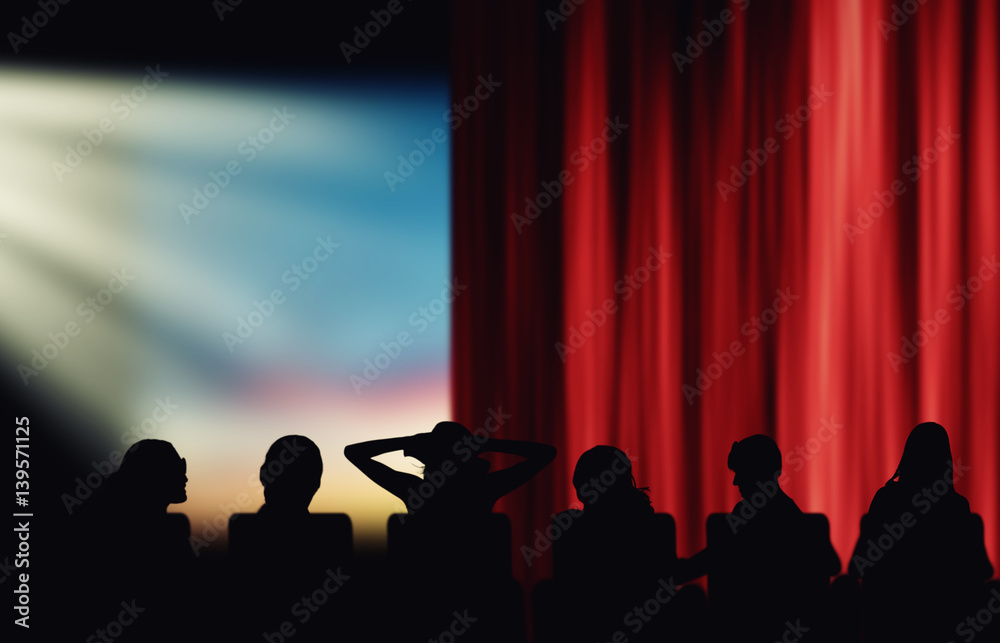 Silhouettes of cinema spectators watching movie