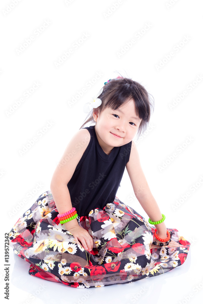 Little cute girl sitting on the floor over white background