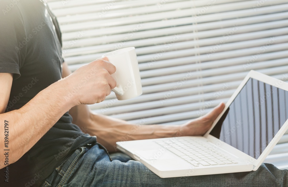 Business man works on laptop.