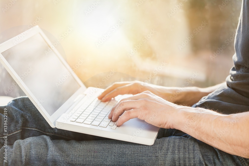 Business man works on laptop.