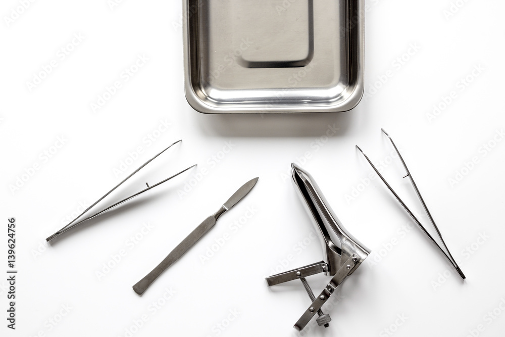 instruments of gynecologist on white background top view