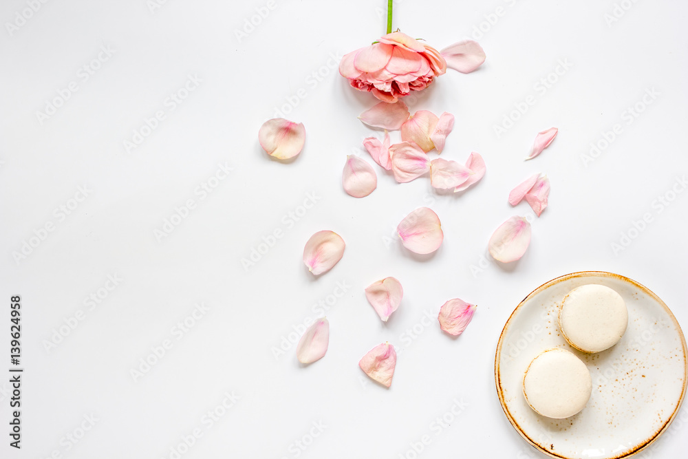 flat lay with petals and macaroons on white background top view mockup