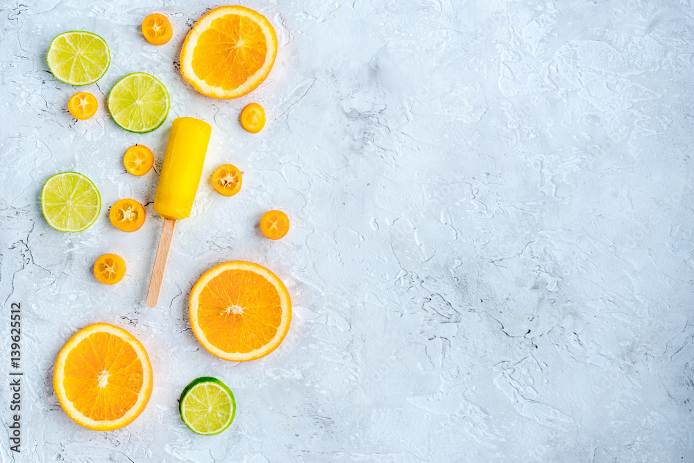 citrus slices with fruit popsicles on table background top view mock up