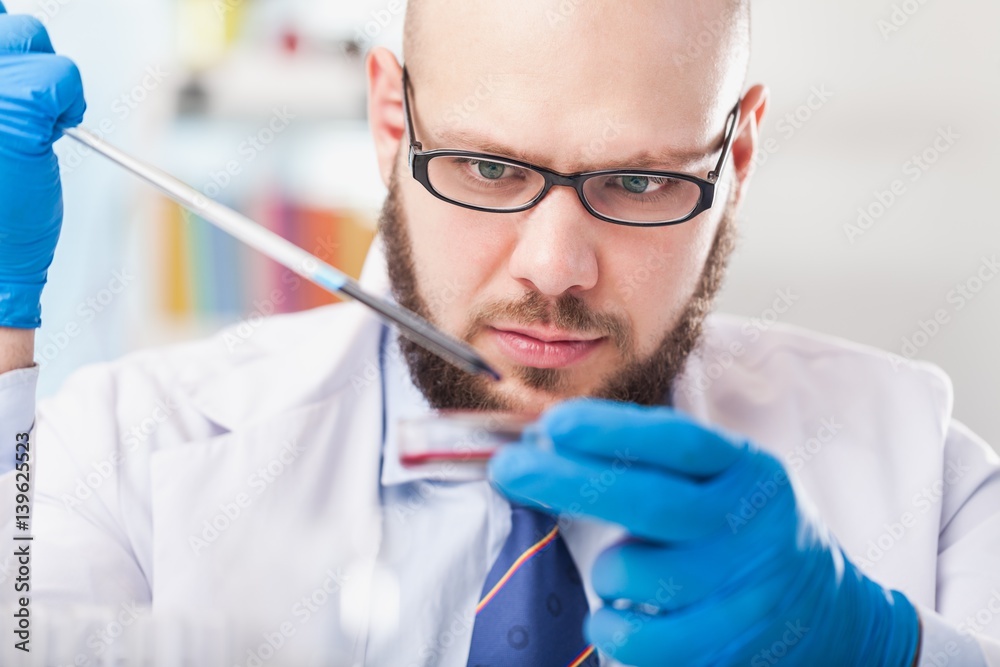 Man researcher carrying out scientific research.