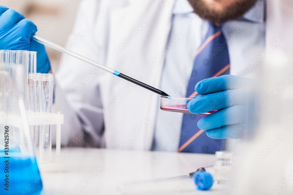 Man researcher carrying out scientific research.