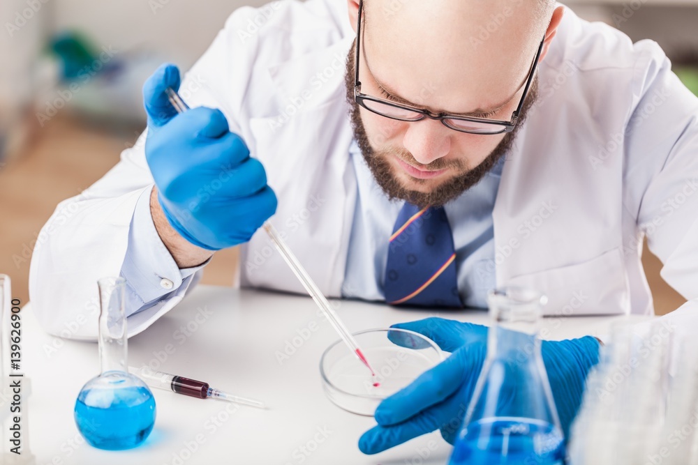 Man researcher carrying out scientific research.