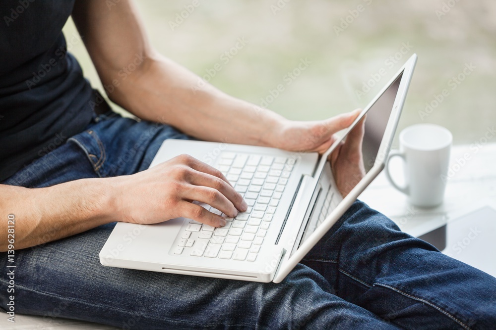 Man works on laptop.