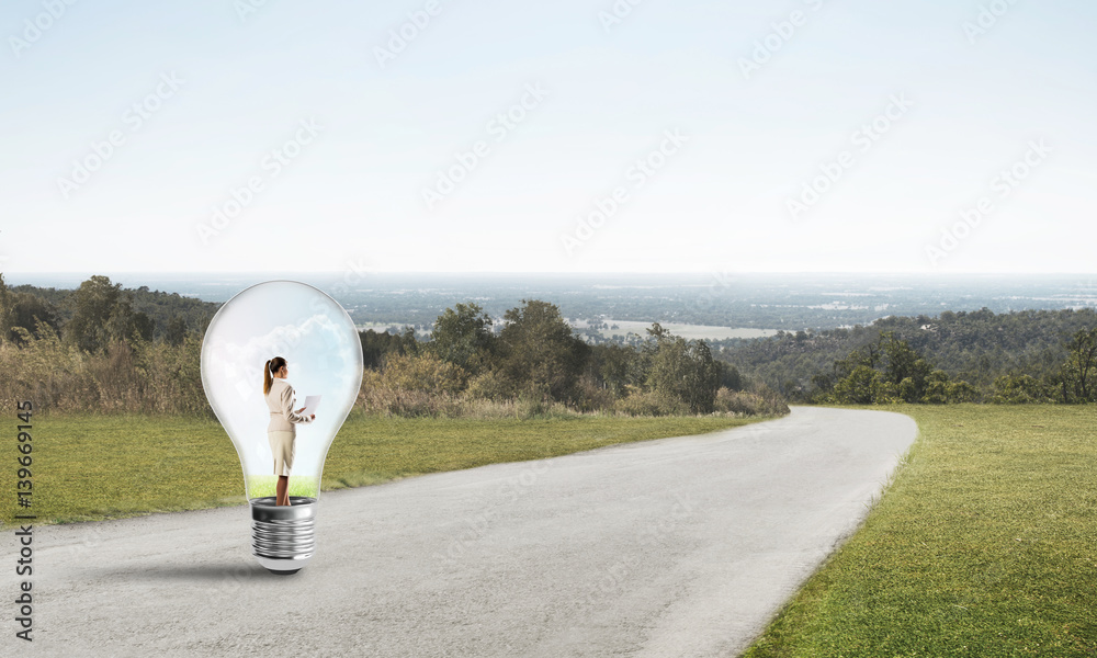 Businesswoman inside light bulb