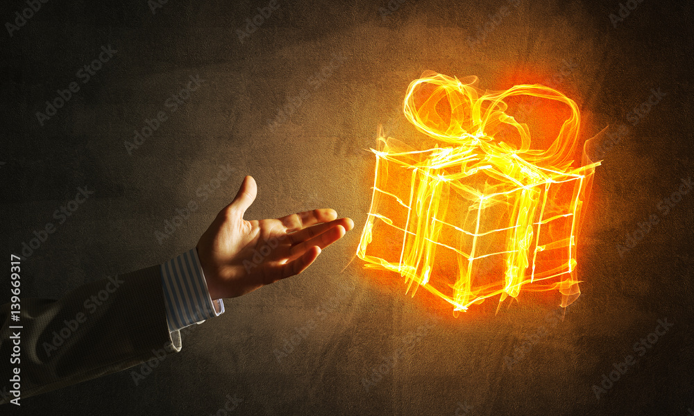 Concept of celebration with fire burning gift symbol and businessman palm