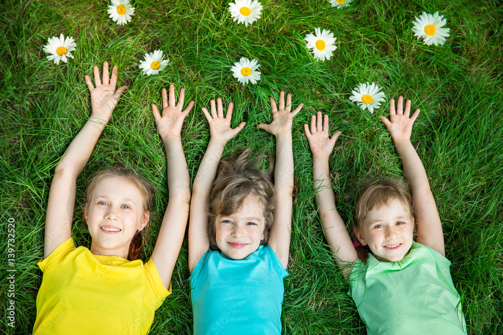 Group of happy children playing outdoors