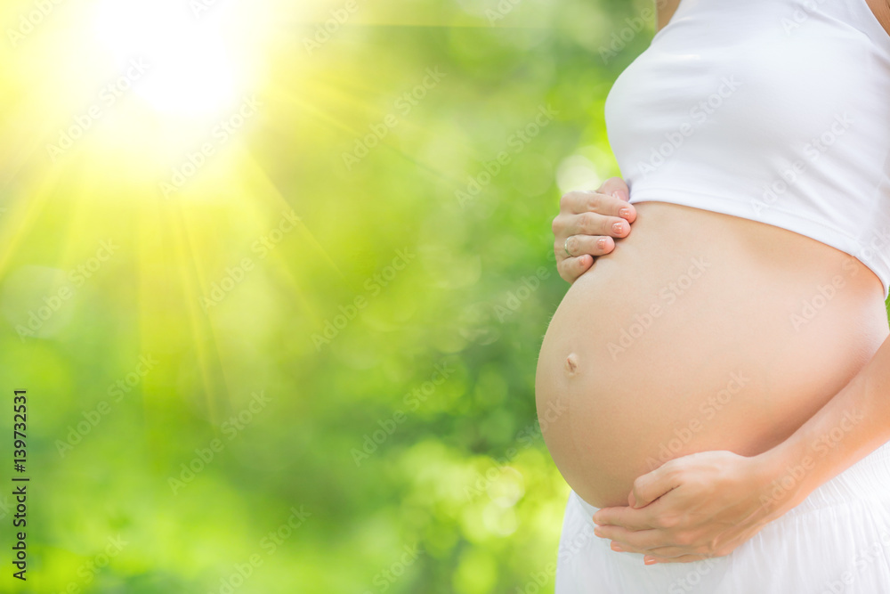 Beautiful belly of young pregnant woman