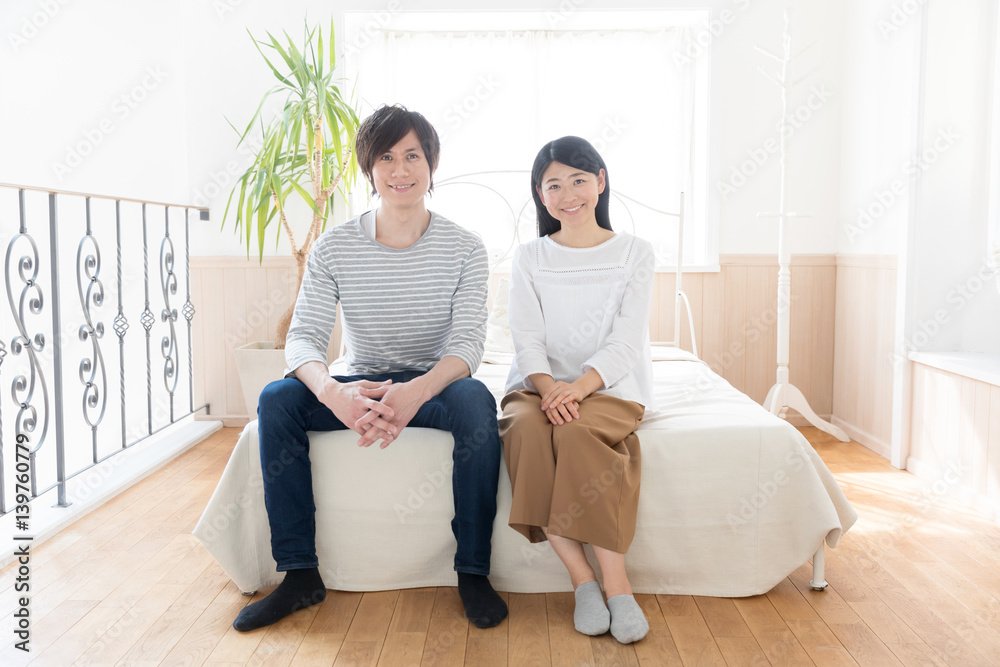 young asian couple relaxing in bedroom