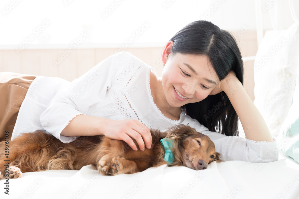 young asian woman sleeping with dog