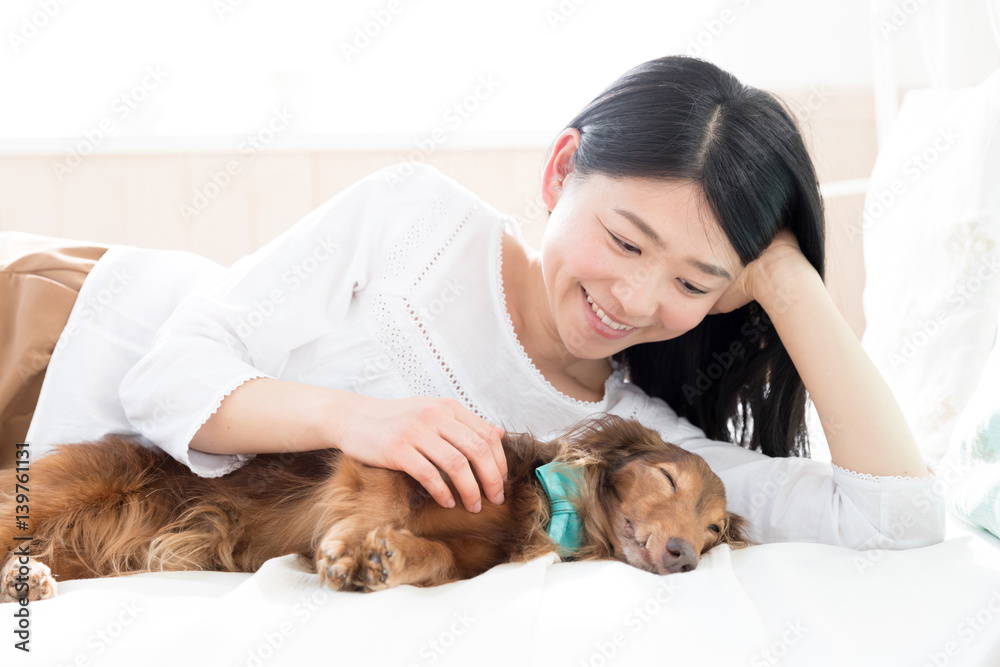 young asian woman sleeping with dog