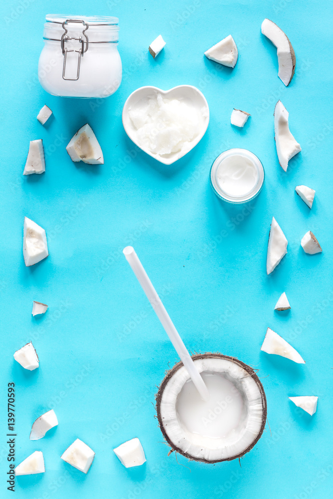 concept organic cosmetics with coconut on blue background top view