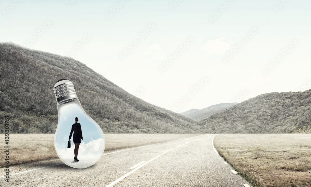 Businesswoman inside light bulb