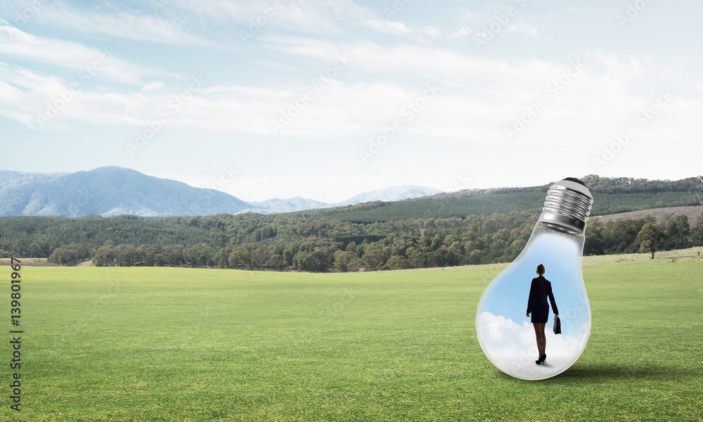 Businesswoman inside light bulb