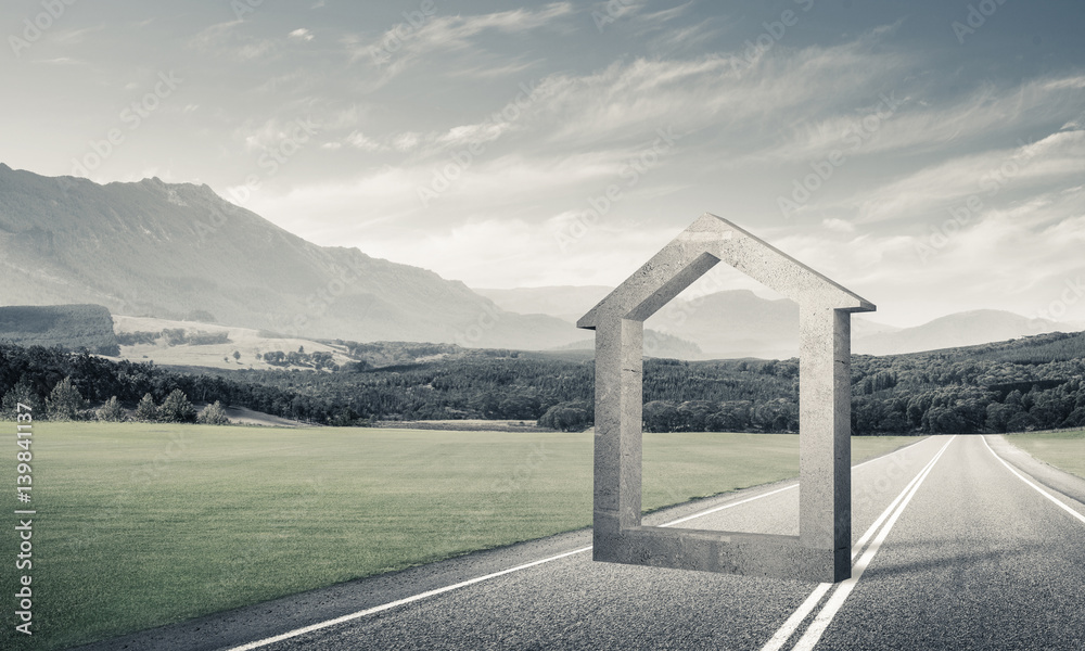 Conceptual background image of concrete home sign on asphalt roa