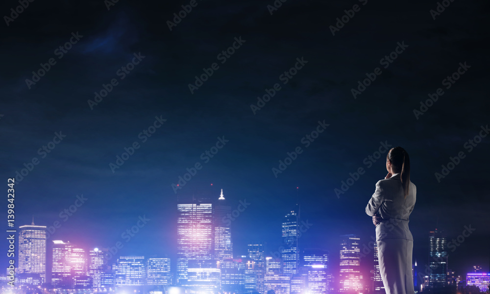 Woman looking at night city