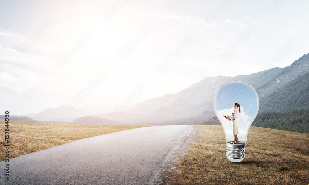 Businesswoman inside light bulb