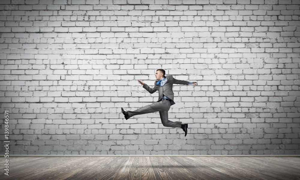 Businessman jumping high