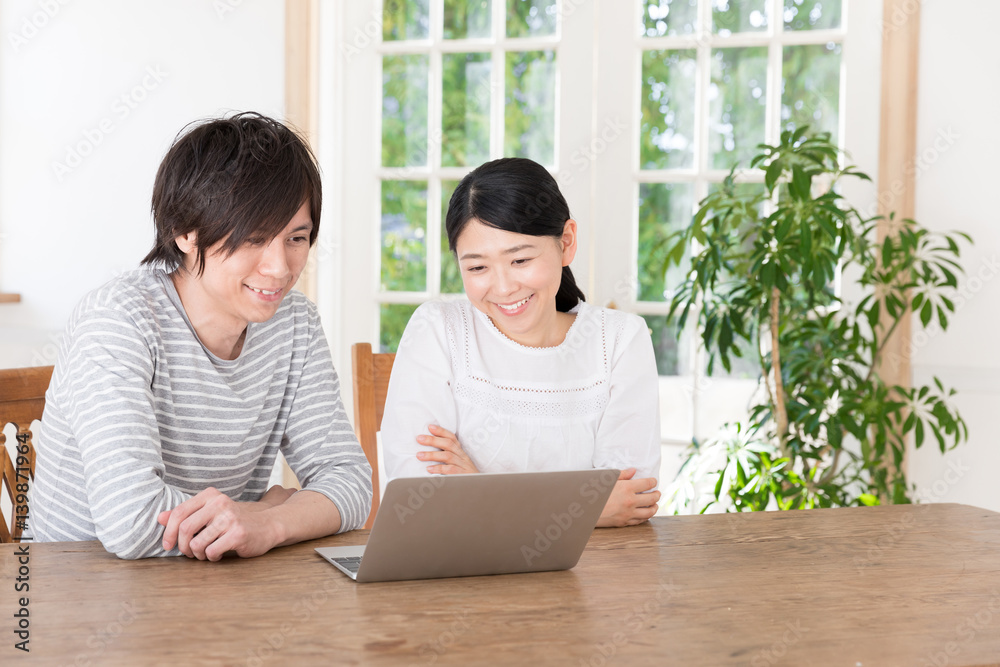 young asian couple using laptop computer