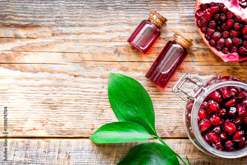 sliced pomegranate on wooden background top view