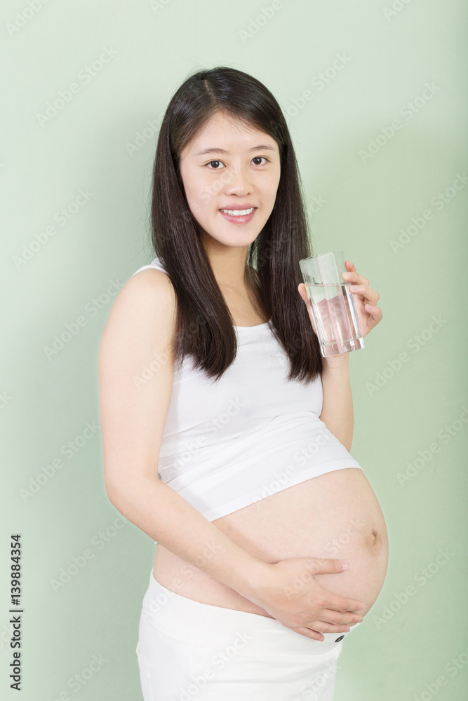 young pretty pregnant woman on background