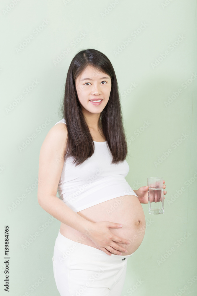 young pretty pregnant woman on background