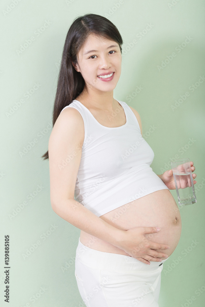 young pretty pregnant woman on background