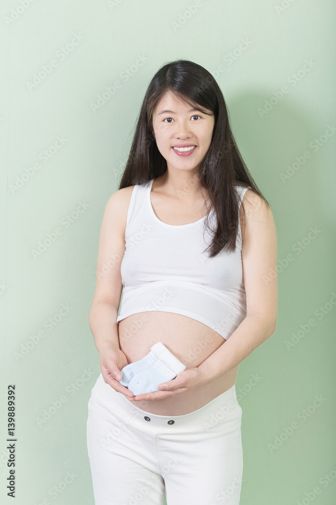 young pretty pregnant woman holds her bellly