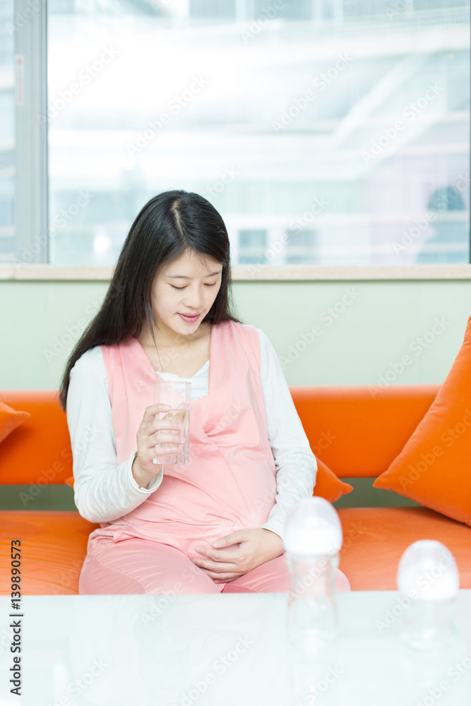 young pretty pregnat woman on sofa