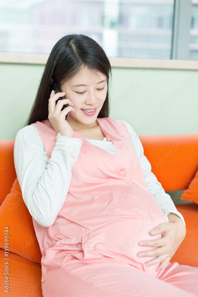 young pretty pregnat woman on sofa