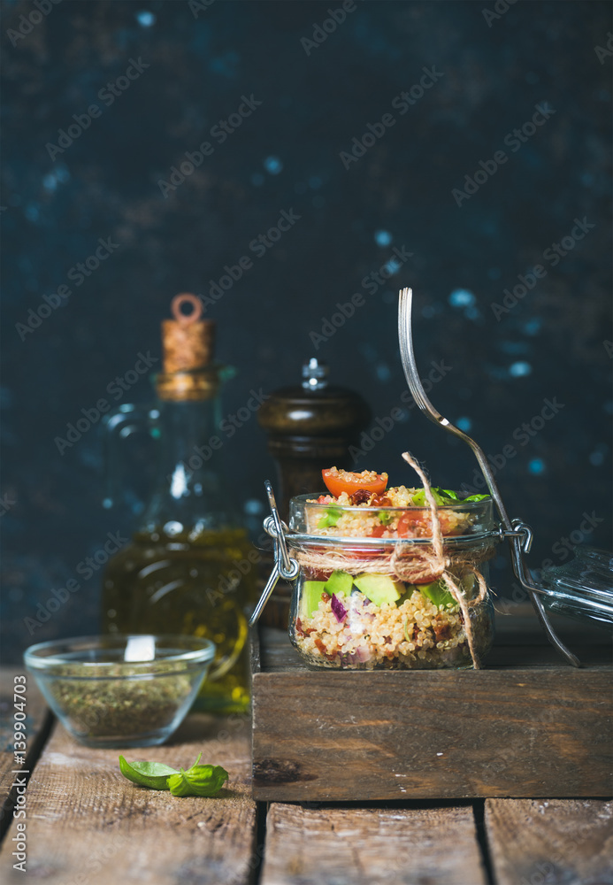 Homemade jar quinoa salad with sun-dried tomatoes, avocado and fresh basil leaves. Detox, dieting, v