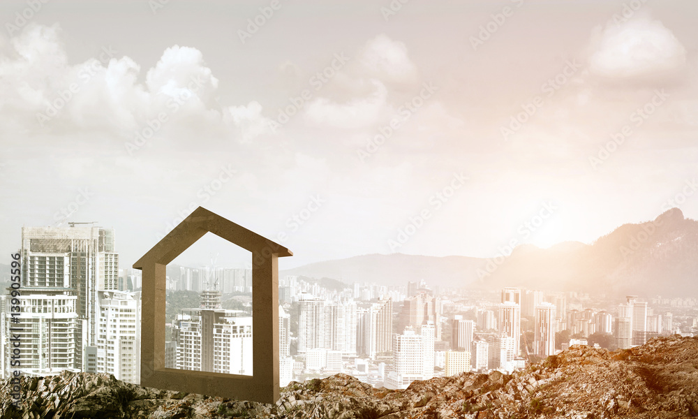 Conceptual image of concrete home sign on hill and natural lands