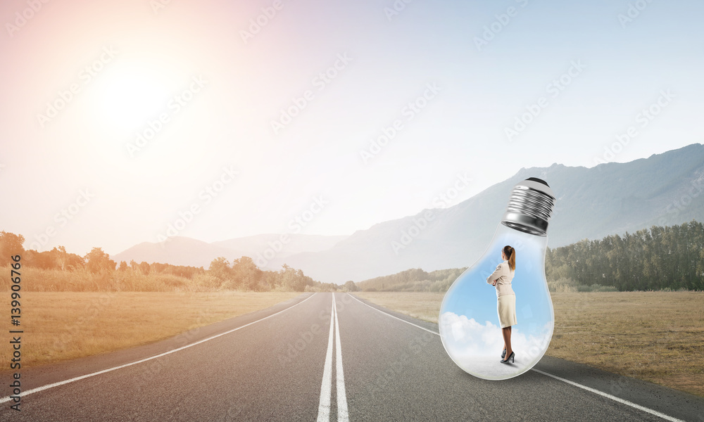 Businesswoman inside light bulb