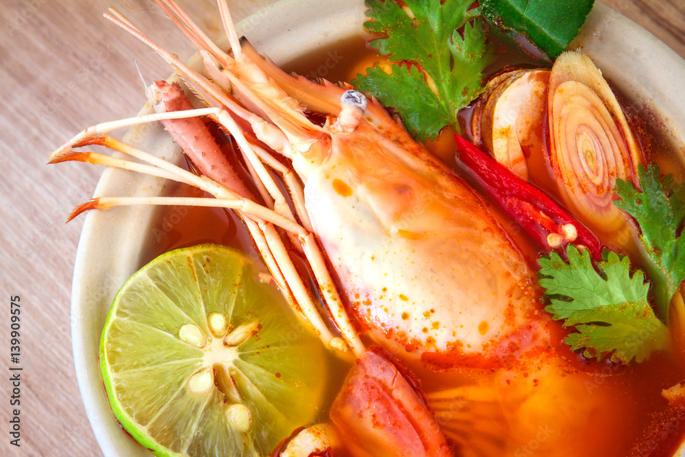 Close up Asian Spicy soup with shrimp in  bowl , famous Thai food cuisine calling Tom Yum Kung