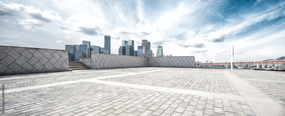 empty floor and modern city in sunny sky