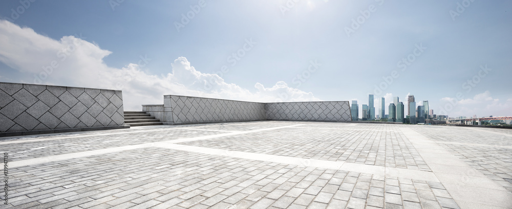 empty floor and modern city in sunny sky