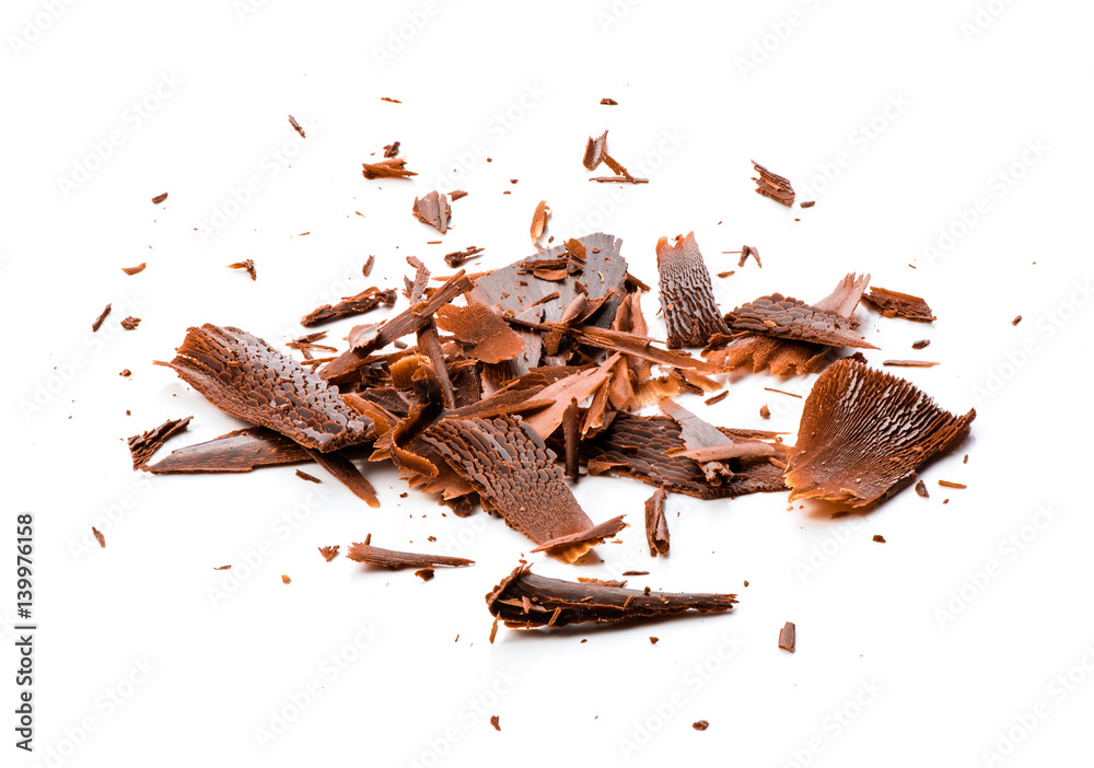 Chocolate chips and curls on white background.