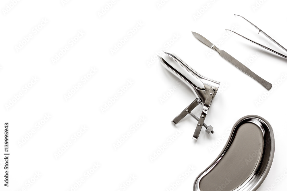 instruments of gynecologist on white background top view