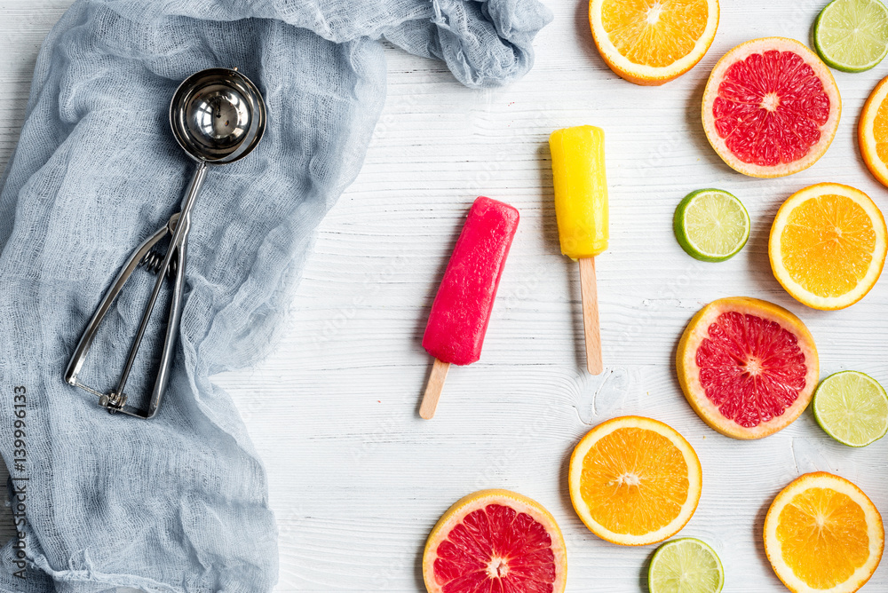 Orange icecream with fruits on table background top view