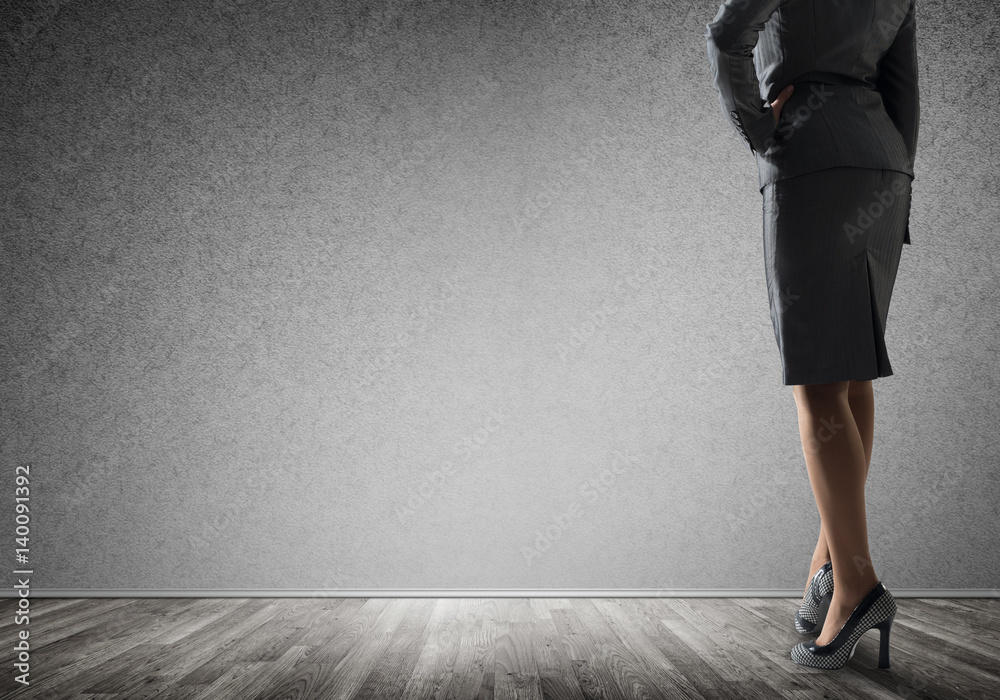 Businesswoman looking at wall