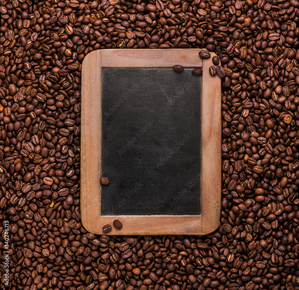 Vintage slate chalk board on coffee beans background with copy space. Texture. Roasted Arabic coffee