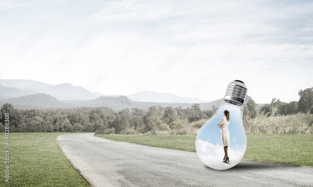 Businesswoman inside light bulb