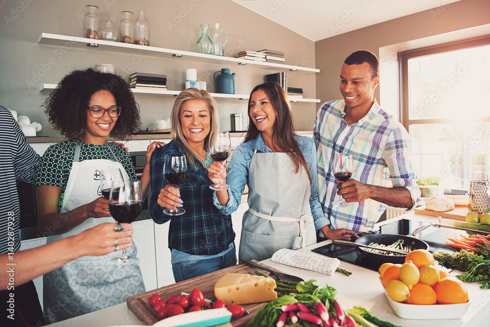 riends cheering while cooking.