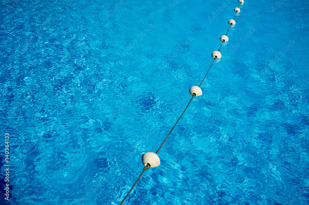 Blue water in the swimming pool, safety buoys